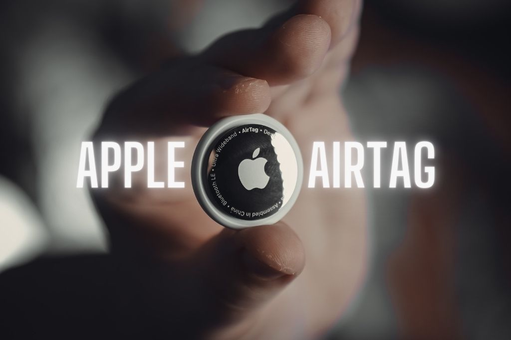 someone holding an Apple AirTag