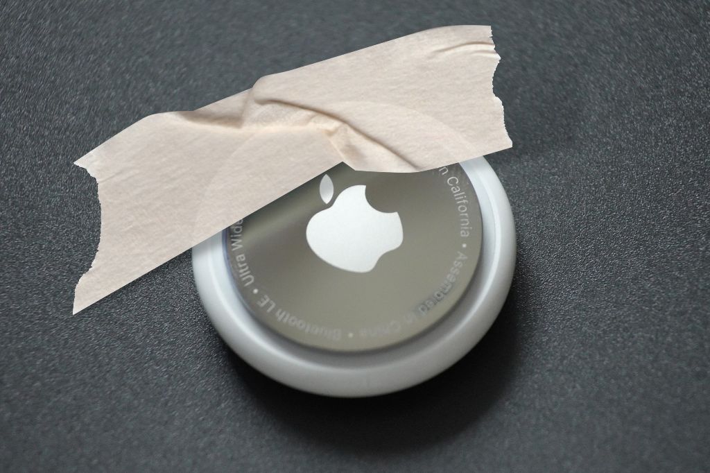 image of an AirTag stuck down using sticky tape